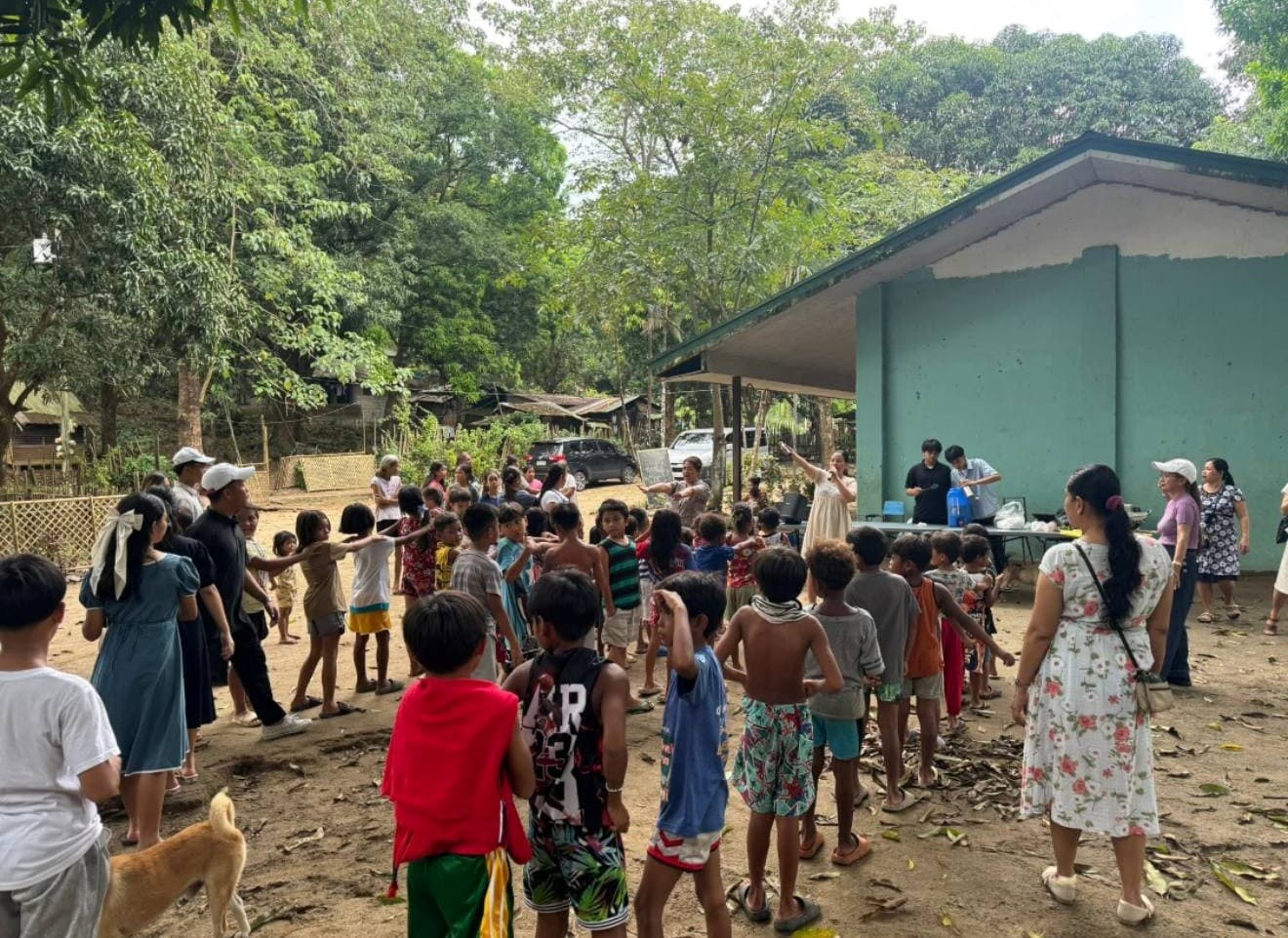 Children and volunteers gathered outside a school building