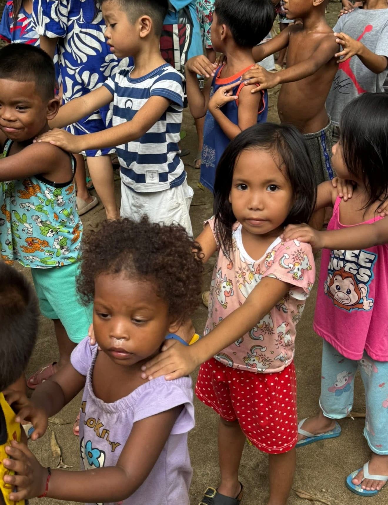 Young children lining up together outdoors